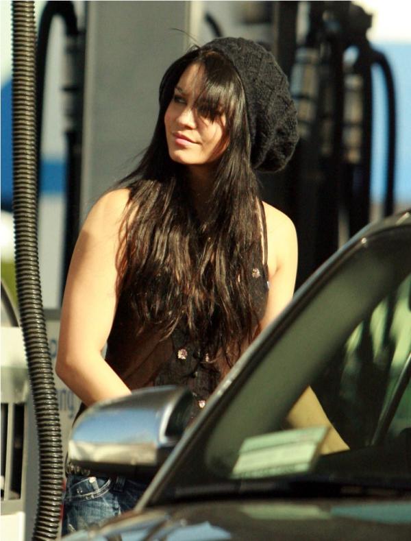 Vanessa Hudgens looking sexy wearing a see-through blouse while pumping gas 